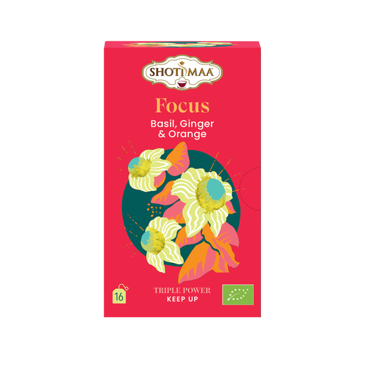 A red box of ShotiMaa Focus Basil, Ginger & Orange tea, featuring colorful illustrations of flowers and green organic certification logos on a white background.